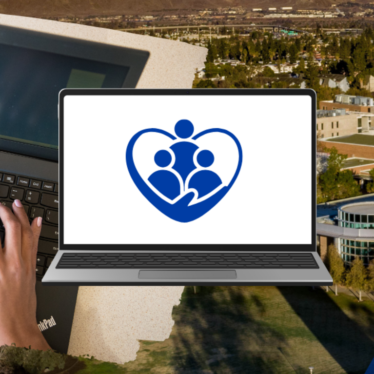 Decorative. Open laptop displaying three people surrounded by a blue heart.