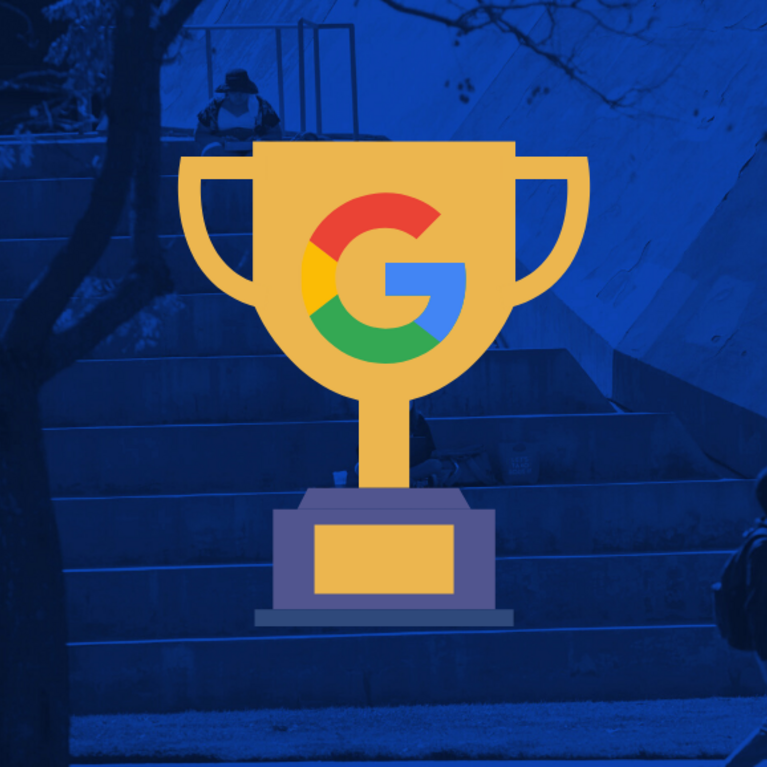 A trophy with a google logo with UCR bell tower in background