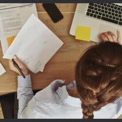 Women Looking At Financial Records On Desk