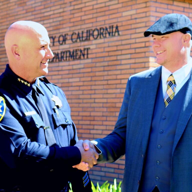 police chief shakes hands with chief information security officer