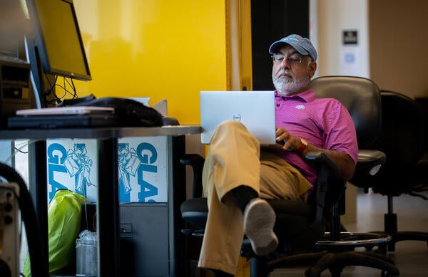 Faculty worker sitting on a laptop