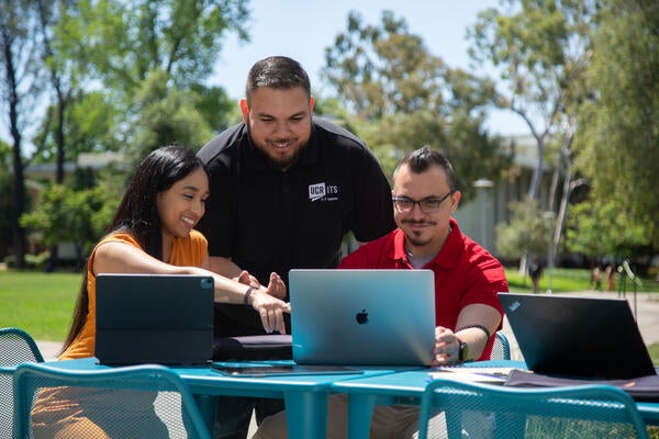 An ITS worker helping staff members.