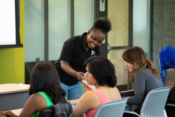 An ITS worker helping a student.