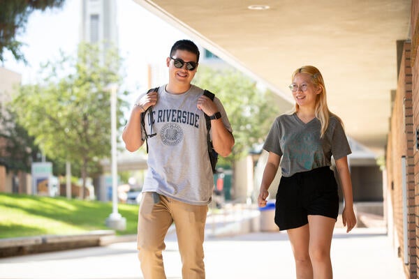 Two Students walking by Skye Hall