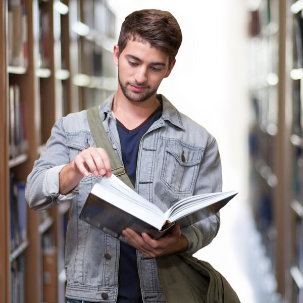 man holds a book in the library