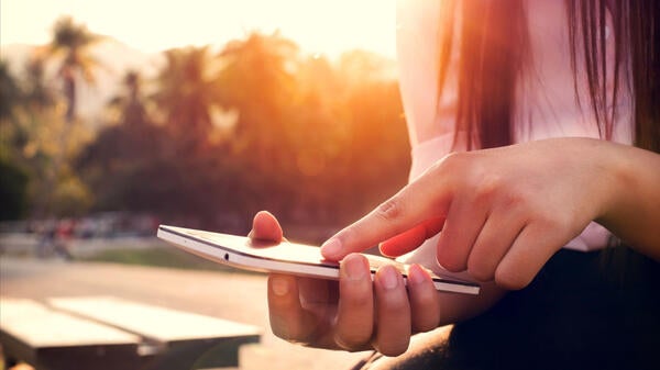 Woman holding and scrolling on a mobile device