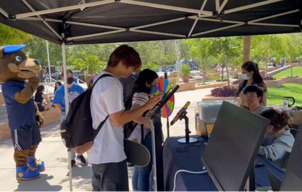 Students testing the new campus user experience at the ITS booth on campus