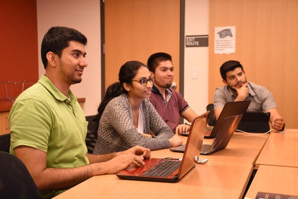 Four Students Looking At Their Computer Screens Information   DSC 7979 