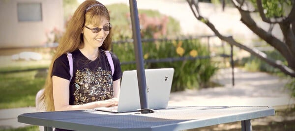 Woman sits at laptop