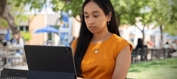 Woman sitting with laptop