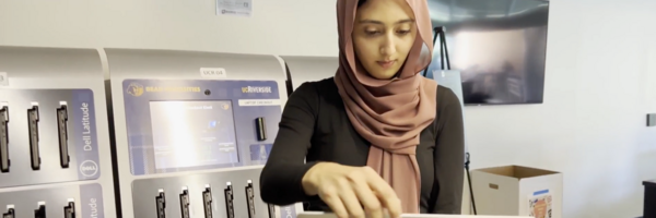 student opens laptop from kiosk