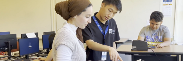 students help each other in computer lab