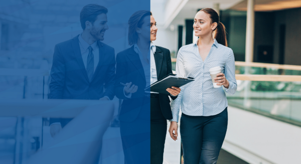 women walk in suits holding coffee