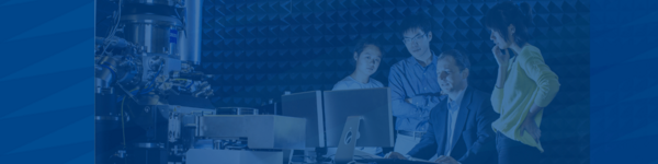 professor guides researcher in front of computer