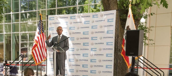 University of California President Michael V. Drake standing behind a podium giving a speech