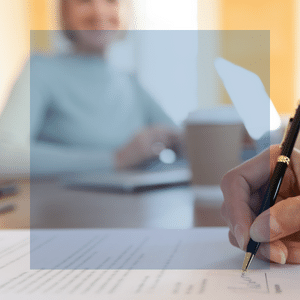 woman gazes over a paper being signed