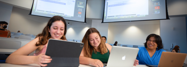 students use devices during a hybrid classroom setting