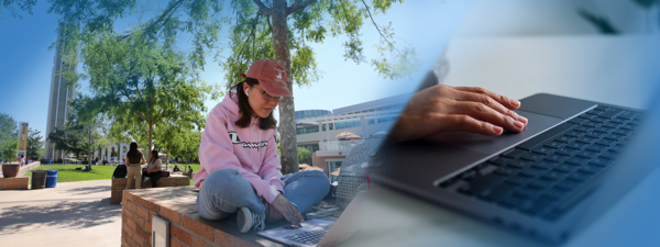 Student typing with laptop