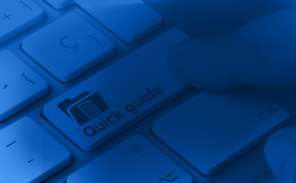 a finger pushing a keyboard button that is labeled quick guide