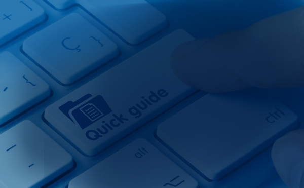 a finger pushing a keyboard button that is labeled quick guide