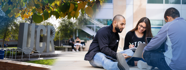 Students gathered around a laptop