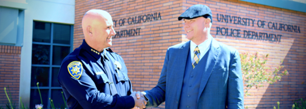 police chief and information security officer shake hands outside police station