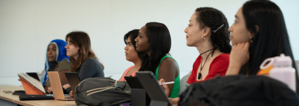 row of engaged students focus on lecturer